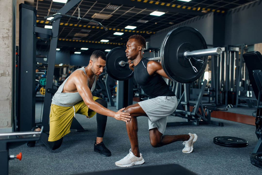 Athletic man and trainer are back weightlifting at a gym after consulting a doctor about: "Can men take collagen peptides?"