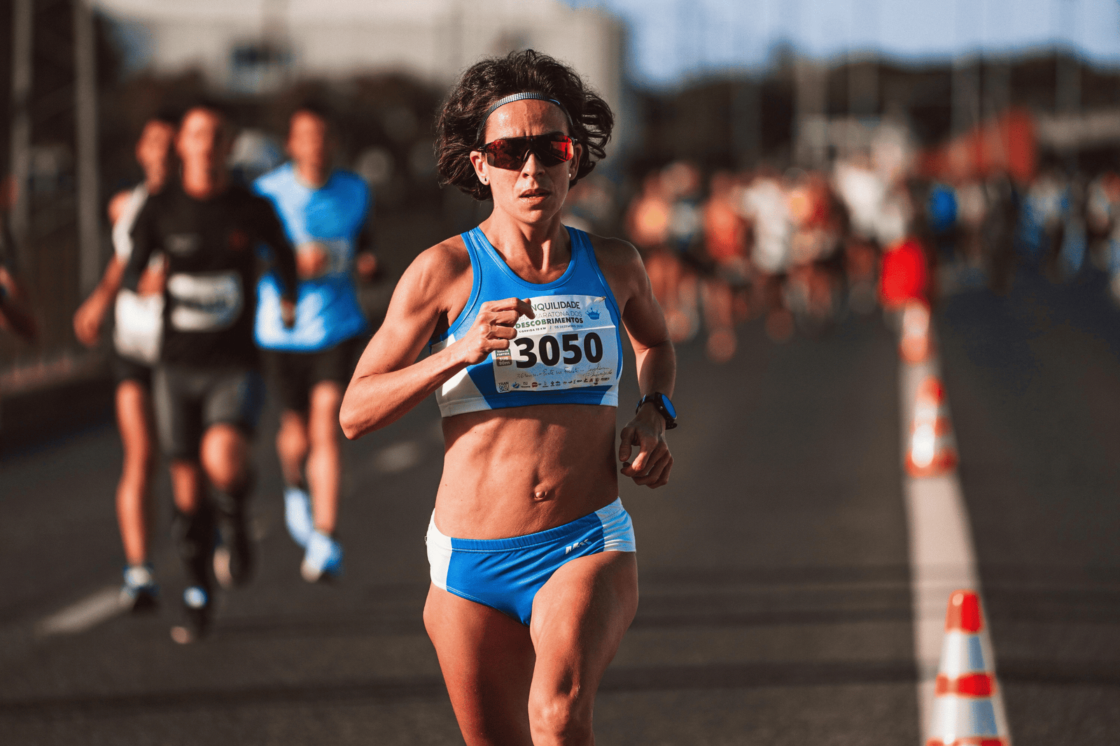 Fit female triathlete running during triathlon, portraying the advantages of protein intake for women