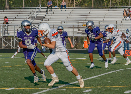 A group of athletes energized by whey protein for football players are playing on a field