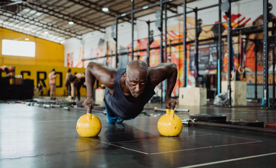 Sportsman supplementing his protein powder for sensitive stomachs with push-ups using yellow kettle bells