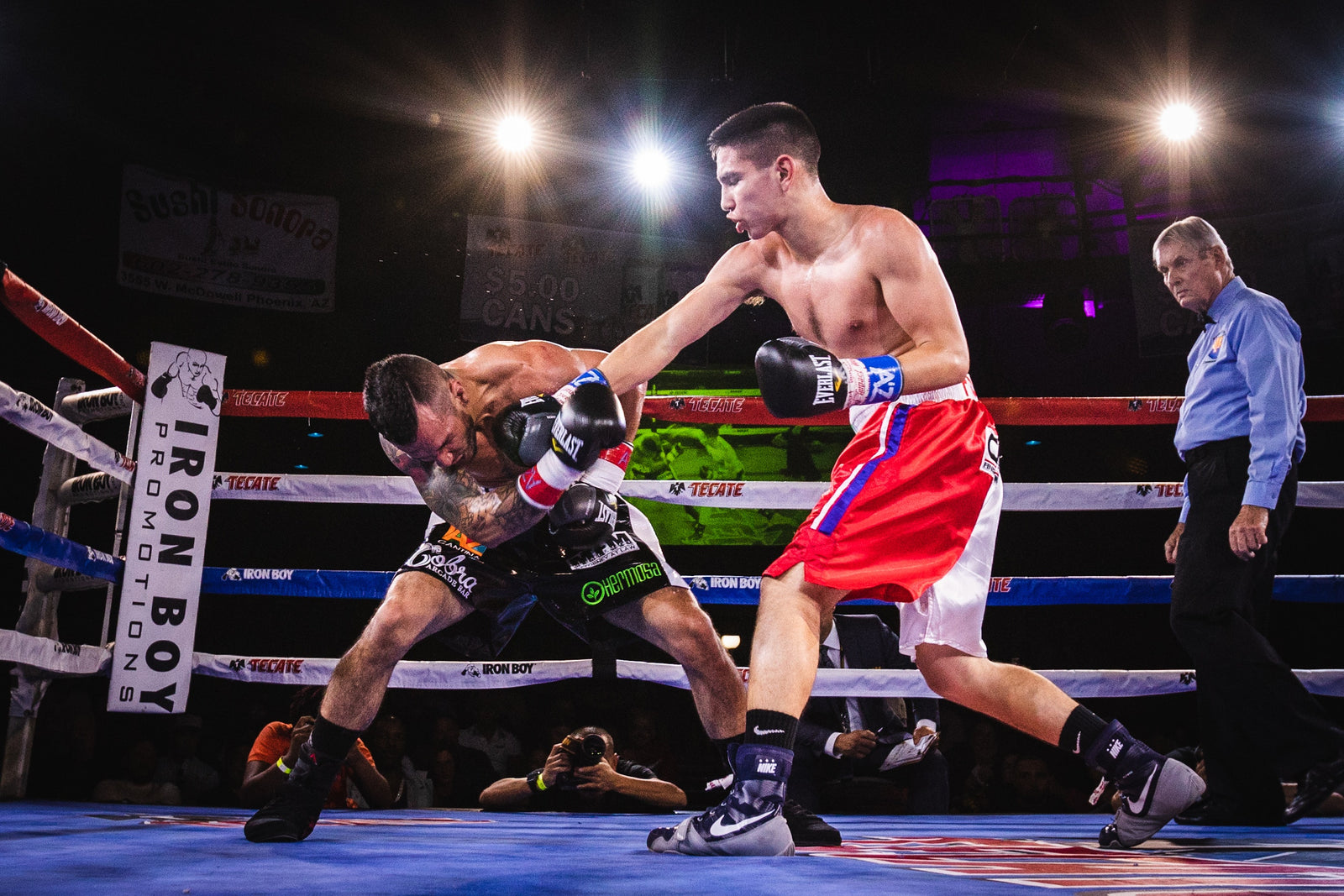 Professional boxer who rigorously trained and took protein for athletes hits his opponent with a jab