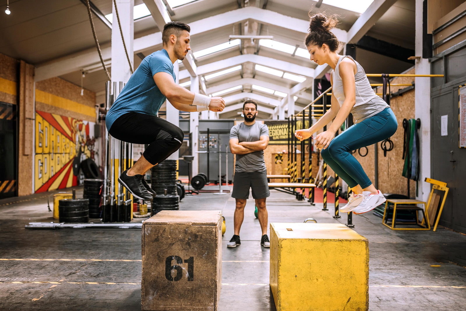 Young people doing crouch-jumping exercises on cross-training after drinking caffeine-free pre-workout