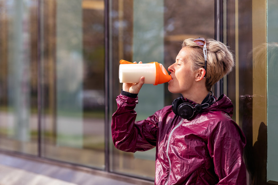 Woman in sportswear drinking a dairy-free protein shake
