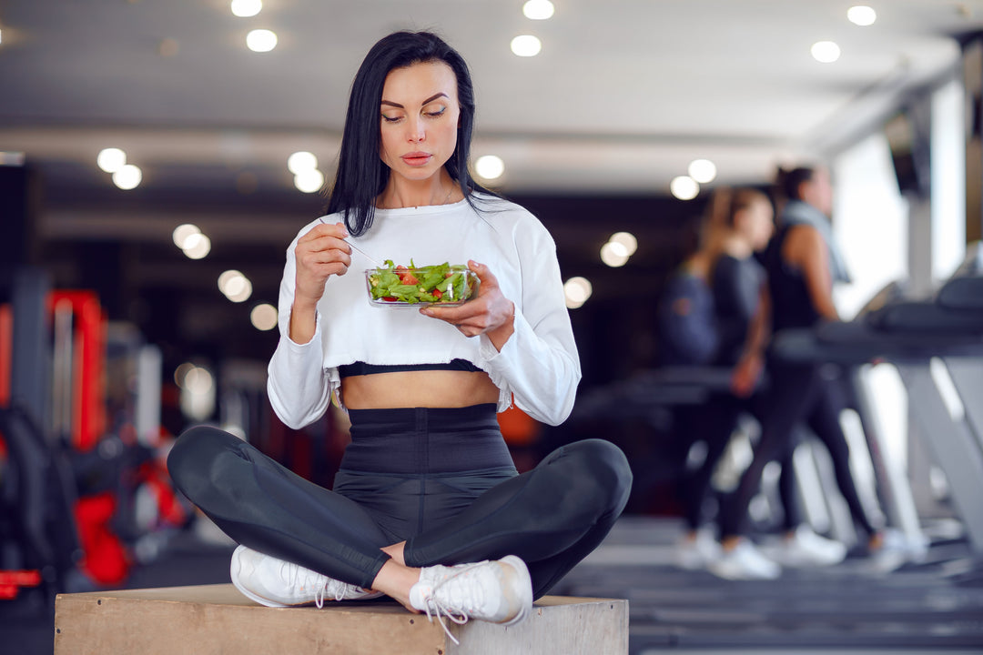 Female athlete eating healthy food to get more protein while in the gym