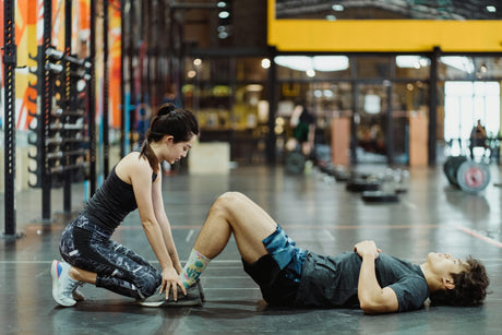 Athletes working out at a gym after taking what to drink during workout